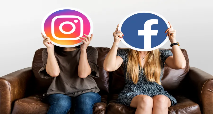 two women sitting on a couch holding the logos of Facebook and Instagram