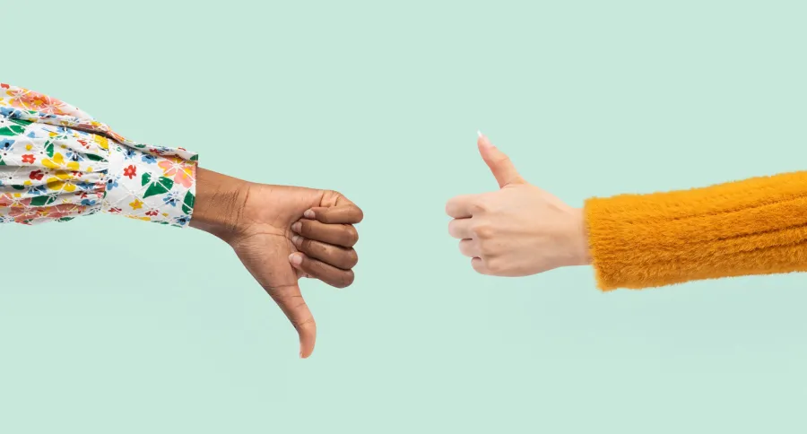 Two hands showing a thumbs up and thumbs down