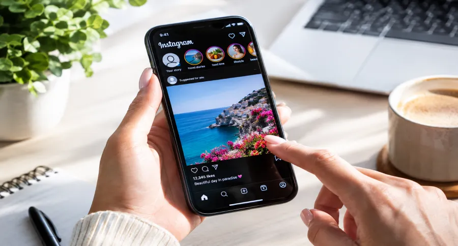 a pair of hands holding a phone with the Instagram app open on it